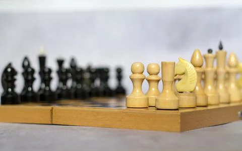 Chess pieces on a chessboard side view, selective focus Stock Photos