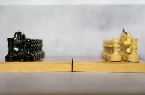 Chess pieces on a chessboard side view, selective focus Stock Photos