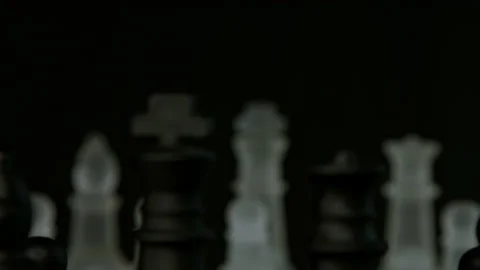 Chess pieces close up face off with pull focus and light glistening pt 1 of 2 Stock Footage 149634848
