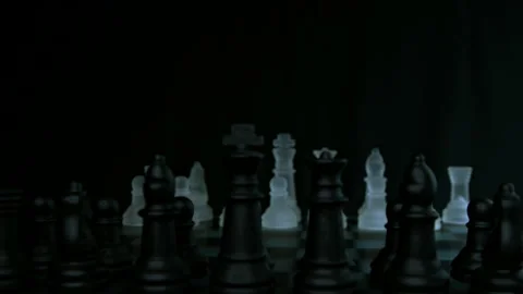 Chess pieces face off with pull focus and light glistening pt 2 of 4 Stock Footage 149631680