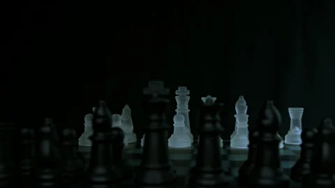 Chess pieces face off with pull focus and light glistening pt 4 of 4 Stock Footage 149634303
