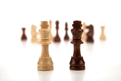 Chess pieces lined up in a row on a gray Stock Photos