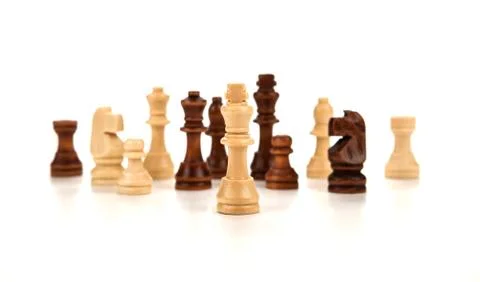 Chess pieces lined up in a row on a gray Stock Photos