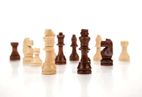 Chess pieces lined up in a row on a gray Stock Photos