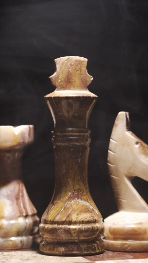 Chess pieces made of stone on a table with decorative design Stock Footage 340482501
