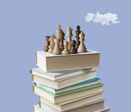 Chess pieces on stack of books. Stock Photos