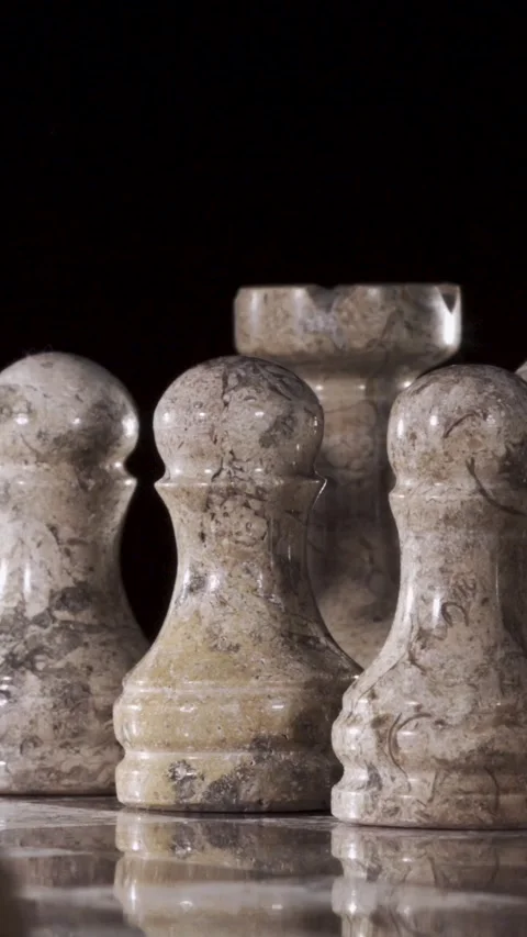 Chess pieces stand ready for a match on a smooth, reflective surface Stock Footage 339303575