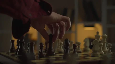A chess player, carefully considering his every move, demonstrates leadershi Stock Footage 263594464
