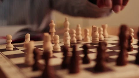 Chess Player Makes Strategic Move on Wooden Board Stock Footage 314628246