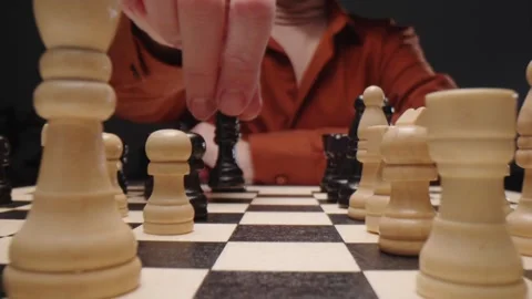 Chess Player Moving Black Piece on Wooden Board During Tactical Strategy Match Видео 331100735