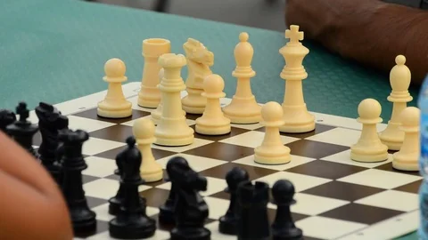 Chess players playing a game in a outdoor chess tournament Stock Footage