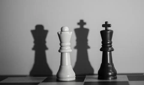 Chess Queen and King Casting Dramatic Shadows: Symbolism of Power, Strategy, and Stock Photos