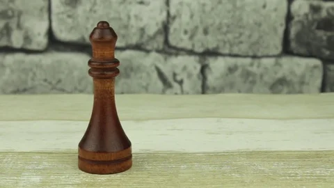 Chess queen on a brick background Stock Footage 78221673