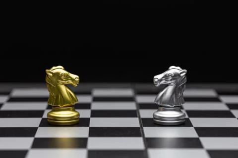 Chess of silver and gold horses face each other in a chess game Stock Photos