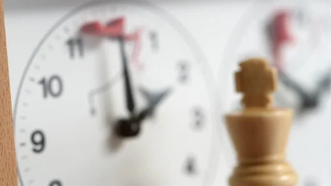 Chess, white king in front of chess clock, which is ticking (with slider) 스톡 동영상 110938264