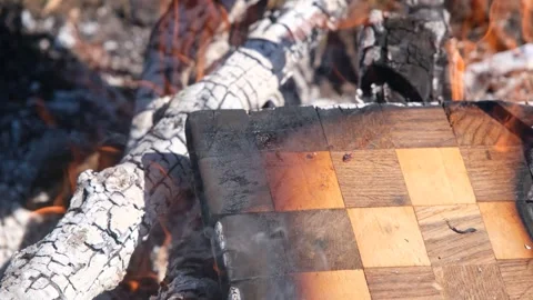 The chessboard is burning in the fire. Burning chessboard. Chessboard on fire Stock Footage 278867978