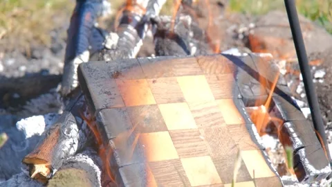 The chessboard is burning in the fire. Burning chessboard. Chessboard on fire Stock Footage 279271408