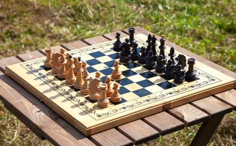 Chessboard with Chess Pieces on Table Stock Photos
