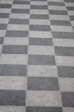 Chessboard pattern in waiting area sidewalk pavement black white checkerboard Foto stock