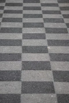 Chessboard pattern in waiting area sidewalk pavement black white checkerboard Foto stock