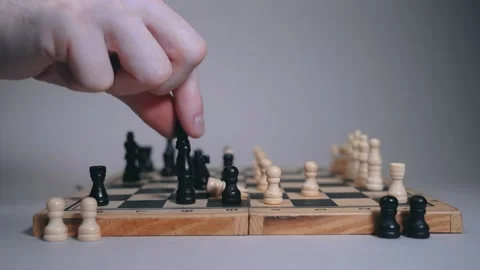 The chessboard on which the game takes place, a man chops down a white piece Vidéo 146754257