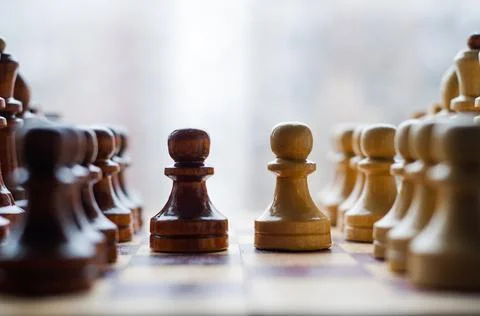 Chessmen on a chessboard, white background, Chess pieces on a chessboard Stock Photos
