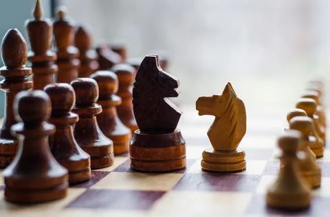 Chessmen on a chessboard, white background, Chess pieces on a chessboard Stock Photos