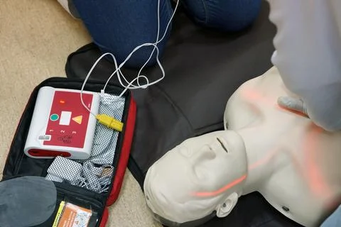 Chest compressions by a student on a simulation dummy during BLS Stock Photos