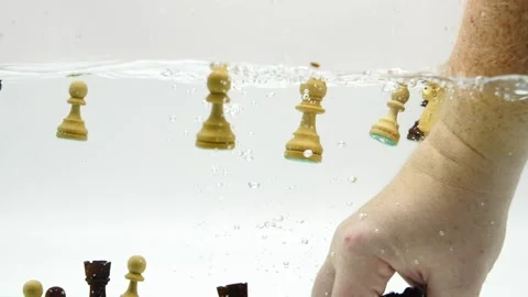 Chest pieces being picked up by hand in slow motion through the water splashing Stock Footage 219288089