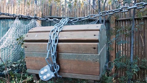 The chest weighs on a chain between the trees Stock Footage 123348015