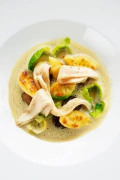 Chestnut and Brussels sprout stew with potato gnocchi and pheasant breast Stock Photos