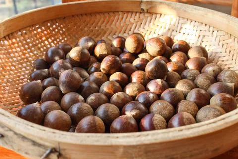 Chestnuts in a basket. Stock Photos