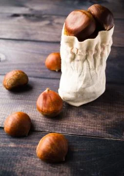 Chestnuts in cotton bag Stock Photos