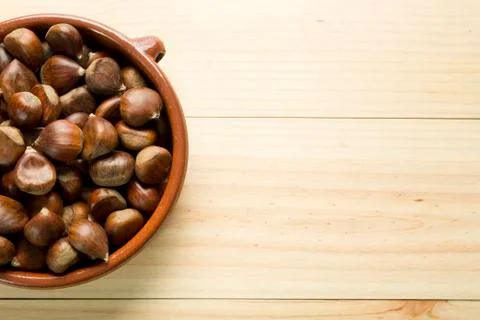 Chestnuts in an earthenware bowl. Stock Photos