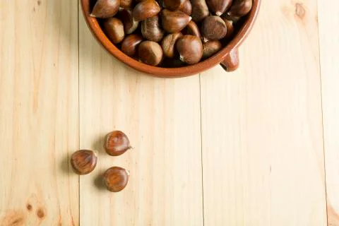 Chestnuts in an earthenware bowl. Stock Photos