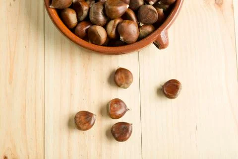 Chestnuts in an earthenware bowl. Stock Photos