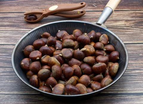 Chestnuts isolated on a table background. Stock Photos