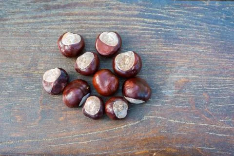 Chestnuts on an old board. Stock Photos