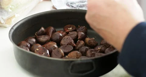 Chestnuts peeled and put in a pot ready for the oven. Stock Footage 143112236