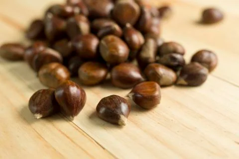 Chestnuts on pine wood background. Stock Photos