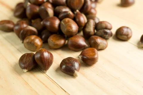 Chestnuts on pine wood background. Stock Photos