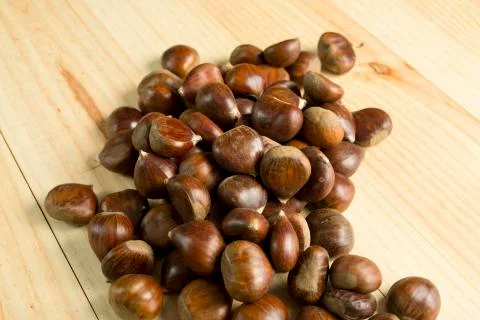 Chestnuts on pine wood background. Stock Photos