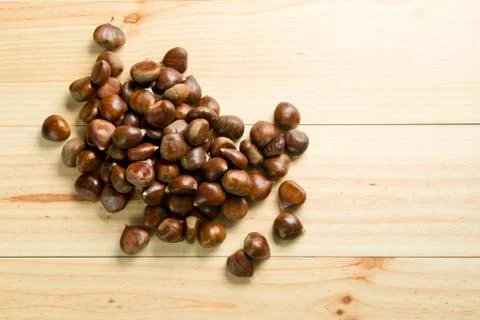 Chestnuts on pine wood background. Stock Photos
