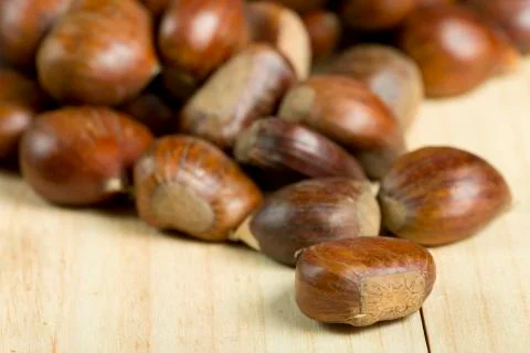 Chestnuts on pine wood background. Stock Photos