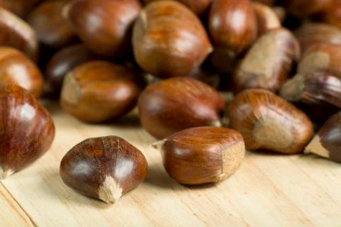 Chestnuts on pine wood background. Stock Photos