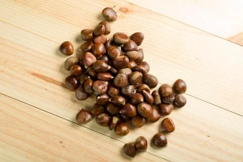 Chestnuts on pine wood background. Stock Photos