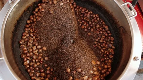 Chestnuts roasting inside rotating drum, showcasing traditional Thailand Stock Footage 317084376