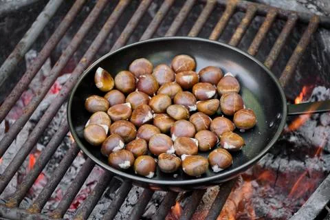 Chestnuts roasting on an open fire Stock Photos