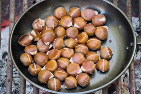 Chestnuts roasting on an open fire Stock Photos