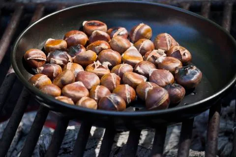 Chestnuts roasting on an open fire Stock Photos